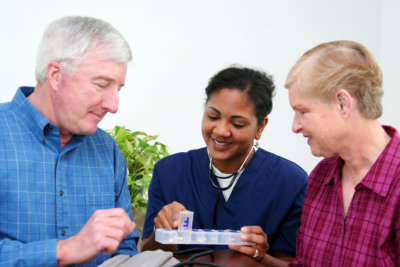 nurse suggesting to senior man on what medicine to take